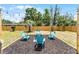 Outdoor seating area with mulch and string lights surrounding a central fire pit and chairs at 410 W Seminole Ave, Eustis, FL 32726
