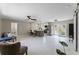 Spacious living room showcases the kitchen, modern floors, and bright light from the glass paneled doors at 410 W Seminole Ave, Eustis, FL 32726
