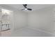 Cozy main bedroom featuring a modern ceiling fan, an ensuite bathroom, and tile flooring at 410 W Seminole Ave, Eustis, FL 32726