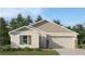 Charming single-story home featuring neutral paint, gabled roof, 2-car garage, and professionally landscaped front yard at 4309 Riverbend Blvd, Haines City, FL 33844