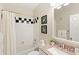 Well-lit bathroom featuring a single vanity, decorative mirror, and shower/tub combo at 476 Water St, Celebration, FL 34747