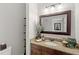 Bathroom featuring granite countertops, decorative mirror, neutral walls, and decor at 476 Water St, Celebration, FL 34747