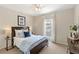 Cozy bedroom featuring a window view, neutral walls, carpet and a ceiling fan at 476 Water St, Celebration, FL 34747