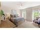 Bright bedroom with two windows, neutral walls, beige carpet and a ceiling fan at 476 Water St, Celebration, FL 34747