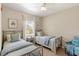 Inviting bedroom with two beds, natural light from a window, and neutral walls at 476 Water St, Celebration, FL 34747