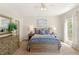 Comfortable bedroom featuring a ceiling fan, neutral walls, and a patterned blue comforter at 476 Water St, Celebration, FL 34747