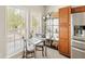 Bright dining area with table, chairs, storage and natural light from a large window at 476 Water St, Celebration, FL 34747