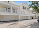 Exterior shot of townhomes with white garage doors and private balconies at 476 Water St, Celebration, FL 34747