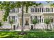 Charming two-story townhouse with black shutters, a well-manicured lawn, and attractive landscaping at 476 Water St, Celebration, FL 34747