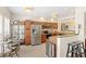Bright kitchen featuring stainless steel appliances, granite countertops and bar-stool seating at 476 Water St, Celebration, FL 34747