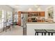 Bright kitchen with stainless steel appliances, granite countertops, and glass-door cabinets at 476 Water St, Celebration, FL 34747