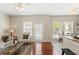 Bright living room with hardwood floors, neutral paint, a ceiling fan, and large windows at 476 Water St, Celebration, FL 34747