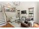 Elegant living room features high ceilings, decorative shelves, designer furnishings, and hardwood floors at 476 Water St, Celebration, FL 34747