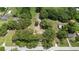 Aerial view of a tree filled lot and surrounding neighborhood on a sunny day at 485 Palm St, Winter Garden, FL 34787