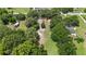 Sun-drenched aerial perspective of a tree filled lot and surrounding neighborhood on a sunny day at 485 Palm St, Winter Garden, FL 34787