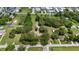 Wide aerial view of a tree filled lot and surrounding neighborhood on a sunny day at 485 Palm St, Winter Garden, FL 34787