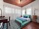 Bright bedroom featuring wood floors, accent rug, and comfortable bed with stylish blue patterned pillows and matching bedding at 485 Palm St, Winter Garden, FL 34787