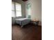 Small bedroom showcasing a single bed, side table, wood flooring, and natural light at 485 Palm St, Winter Garden, FL 34787
