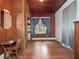Inviting bedroom featuring wood paneled walls, and a sunlit window with blue curtains at 485 Palm St, Winter Garden, FL 34787