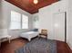 Cozy bedroom features wood-paneled ceiling, hardwood floors, neutral walls, and twin bed, creating a comfortable space at 485 Palm St, Winter Garden, FL 34787
