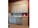 Vintage kitchen featuring original cabinets, sink, and countertop space at 485 Palm St, Winter Garden, FL 34787