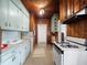 Functional kitchen with vintage-style cabinetry, a white gas range, and ample counter space for cooking at 485 Palm St, Winter Garden, FL 34787