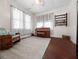 Bright and spacious room, complete with a piano, rocking chair and natural light from the large windows at 485 Palm St, Winter Garden, FL 34787
