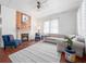 Cozy living room with a decorative fireplace, hardwood floors, and a comfortable sofa and chair set at 485 Palm St, Winter Garden, FL 34787