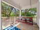 Inviting porch with a comfortable swing adorned with colorful pillows and a beautiful outdoor view at 485 Palm St, Winter Garden, FL 34787