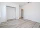 A bright bedroom with an open closet and light grey wood-look flooring at 509 St. Johns Ct, Poinciana, FL 34759
