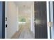 View from the front door into a bright, open-concept living space with sleek gray flooring at 509 St. Johns Ct, Poinciana, FL 34759