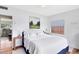 Well-lit bedroom featuring a plush bed, natural light, hardwood floors, and calming neutral decor at 5384 Barton Dr, Orlando, FL 32807