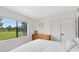 Bright bedroom with a large window offering views of the grassy back yard, a closet, and hardwood floors at 5384 Barton Dr, Orlando, FL 32807