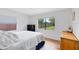 Comfortable bedroom featuring two windows providing ample light and backyard views with hardwood flooring at 5384 Barton Dr, Orlando, FL 32807