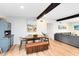 Open-concept dining area featuring a rustic hutch, a wooden table with seating, and exposed wood beams at 5384 Barton Dr, Orlando, FL 32807