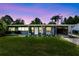 Charming single-story home featuring a well-maintained lawn and stylish curb appeal enhanced by an attached carport at 5384 Barton Dr, Orlando, FL 32807