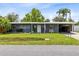 Inviting single-story home with a carport, green lawn, and neatly maintained landscaping at 5384 Barton Dr, Orlando, FL 32807