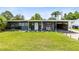 Lovely one-story home featuring an open carport, tidy lawn, and welcoming front porch at 5384 Barton Dr, Orlando, FL 32807