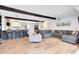 Inviting living room features wood beam, breakfast bar, modern decor, sleek floors and an open-concept design at 5384 Barton Dr, Orlando, FL 32807