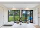Bright sun room with large windows overlooking the spacious backyard complete with lush greenery and a playset at 5384 Barton Dr, Orlando, FL 32807