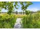 Scenic view of a tranquil lake and fishing dock, framed by lush foliage, perfect for nature lovers at 5384 Barton Dr, Orlando, FL 32807
