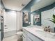 Bathroom with tub-shower combo, a large vanity, neutral decor, and a stylish mirror at 564 Southern Edge Way, Sanford, FL 32771