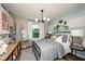 Comfortable bedroom featuring a bed with neutral bedding, stylish decor, and a view of the outdoors at 564 Southern Edge Way, Sanford, FL 32771