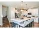 Bright kitchen with white cabinets, stainless steel appliances, an island with seating, and pendant lighting at 564 Southern Edge Way, Sanford, FL 32771