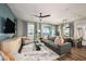 Comfortable living room featuring a gray sofa, stylish decor, and views of the outdoors through large windows at 564 Southern Edge Way, Sanford, FL 32771