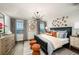 Serene main bedroom featuring a large bed, stylish decor, and views of the water through windows at 564 Southern Edge Way, Sanford, FL 32771