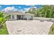 An impressive backyard patio features a built-in fire pit and plenty of room for outdoor entertaining at 6013 Mount Zion Cir, Deland, FL 32724