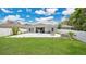Expansive backyard featuring a well-maintained lawn and a large paver patio at 6013 Mount Zion Cir, Deland, FL 32724