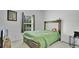 Cozy bedroom featuring a comfortable bed with a green cover and a window with curtains at 6013 Mount Zion Cir, Deland, FL 32724