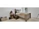 Bedroom with a queen bed, side table, and natural light from the window at 6013 Mount Zion Cir, Deland, FL 32724